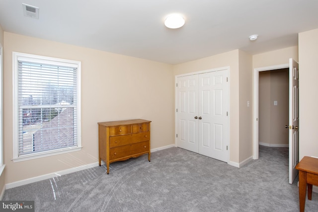 bedroom featuring baseboards, a closet, visible vents, and carpet flooring