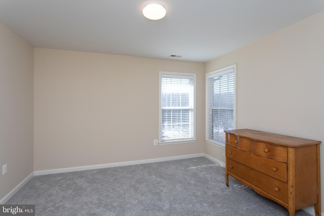 unfurnished bedroom featuring carpet, visible vents, and baseboards