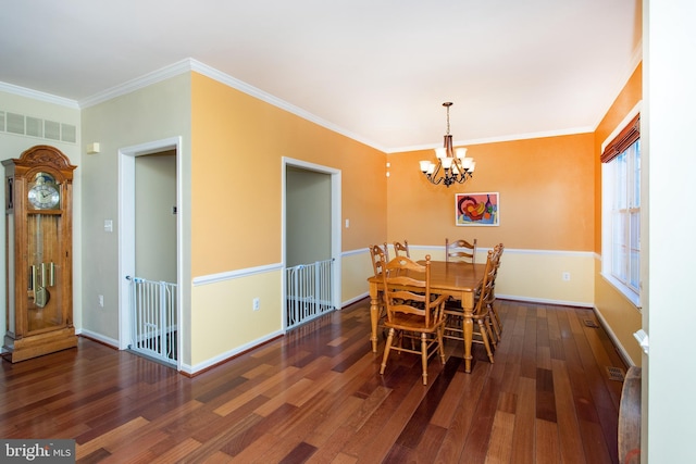 dining room featuring baseboards, visible vents, wood finished floors, and ornamental molding