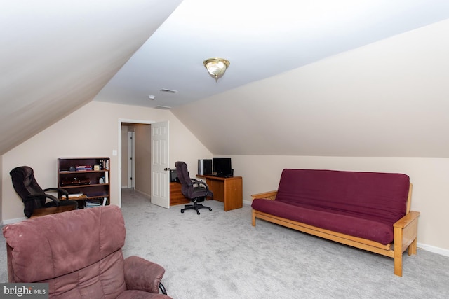 carpeted office space featuring baseboards, visible vents, and vaulted ceiling