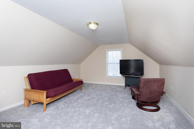 sitting room with lofted ceiling, baseboards, and carpet flooring