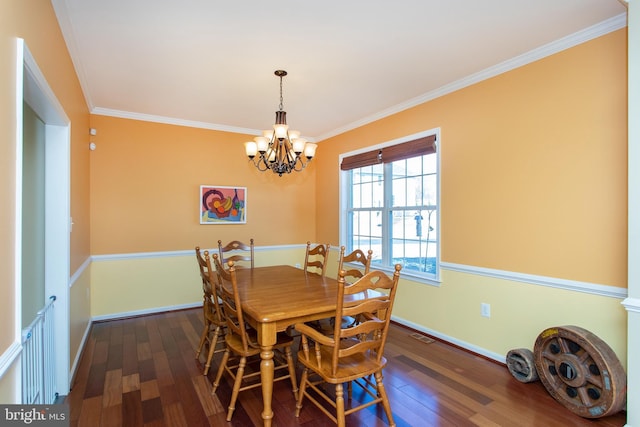 dining space with a notable chandelier, baseboards, ornamental molding, and wood finished floors