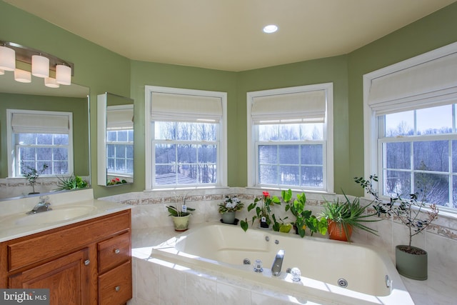 bathroom featuring a jetted tub and vanity