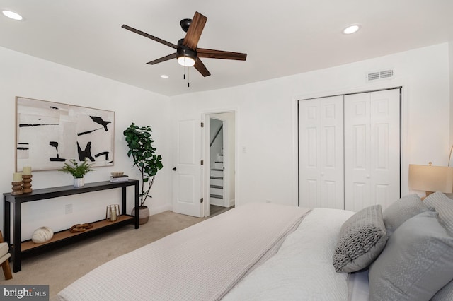 carpeted bedroom featuring ceiling fan, visible vents, a closet, and recessed lighting