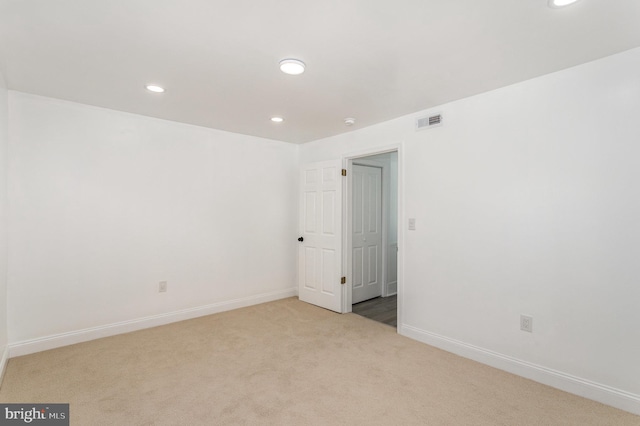 carpeted spare room with recessed lighting, visible vents, and baseboards