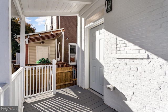 doorway to property featuring brick siding