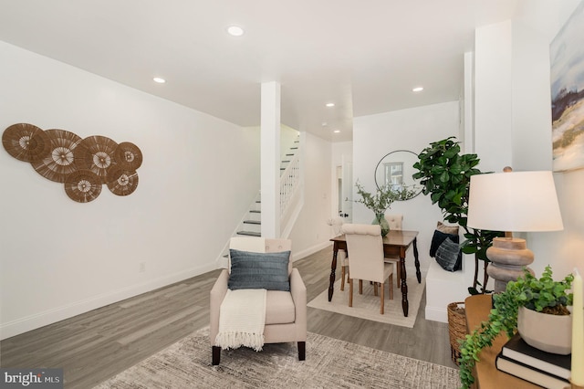 sitting room with recessed lighting, stairway, and wood finished floors