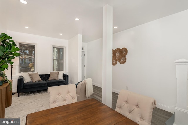 living room featuring recessed lighting, baseboards, and wood finished floors