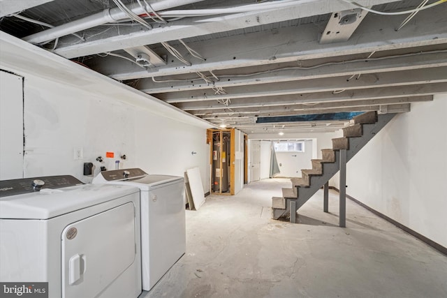 below grade area with washing machine and dryer, water heater, and stairs