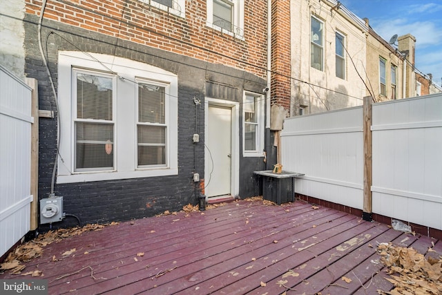 wooden terrace featuring fence