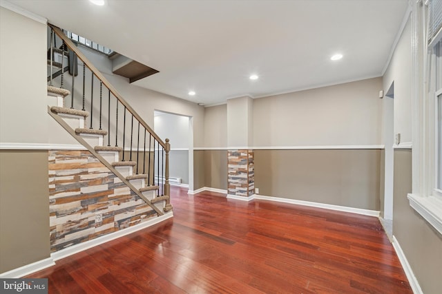 empty room featuring baseboards, wood finished floors, and recessed lighting