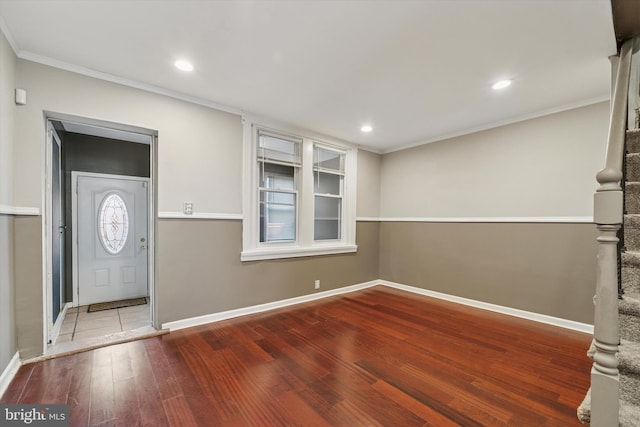 entryway featuring crown molding, recessed lighting, wood-type flooring, and baseboards