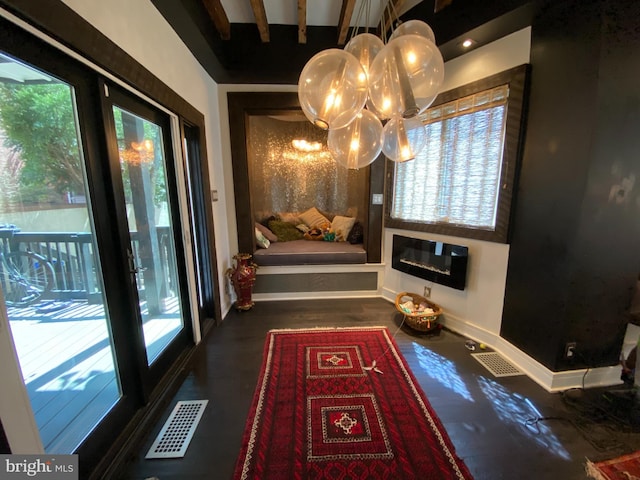 interior space with baseboards, heating unit, visible vents, and a notable chandelier