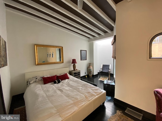 bedroom with vaulted ceiling with beams, baseboards, visible vents, and dark wood finished floors