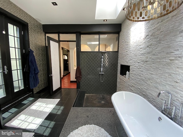 bathroom featuring tile patterned floors, a freestanding bath, tiled shower, and french doors