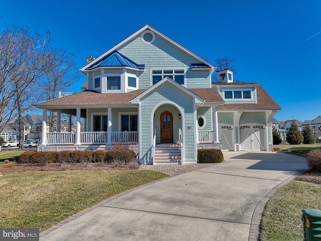 view of front facade featuring a porch, a shingled roof, an attached garage, a front yard, and driveway