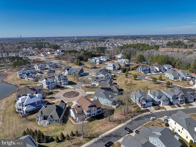 drone / aerial view with a water view and a residential view