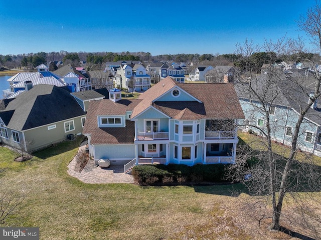 bird's eye view with a water view and a residential view