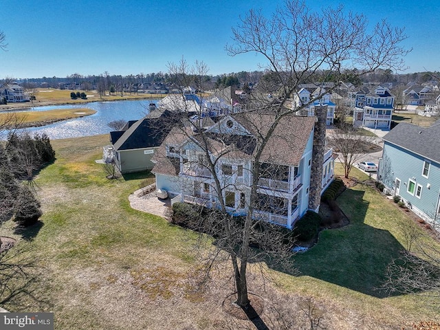 drone / aerial view with a water view and a residential view