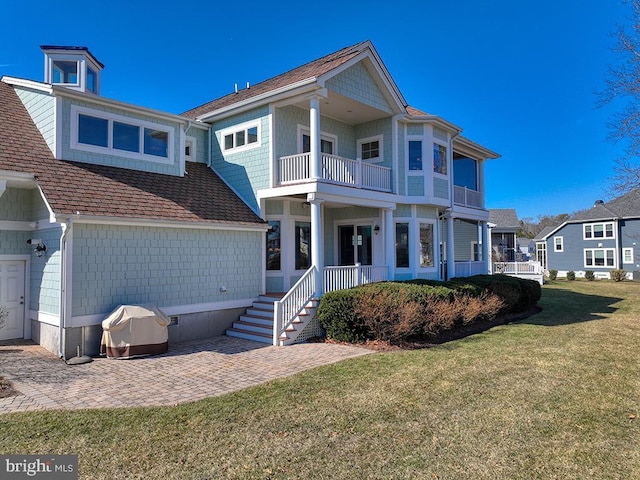 view of front of house with a balcony, crawl space, and a front lawn