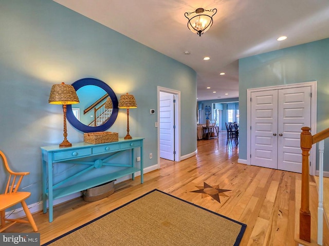 foyer entrance featuring recessed lighting, light wood-style flooring, and baseboards