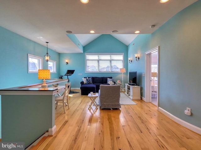 living area featuring light wood finished floors, baseboards, vaulted ceiling, and recessed lighting