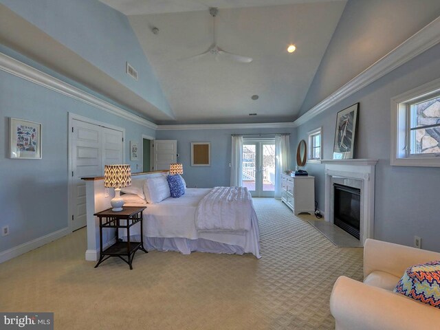 bedroom featuring access to exterior, a premium fireplace, visible vents, and light colored carpet