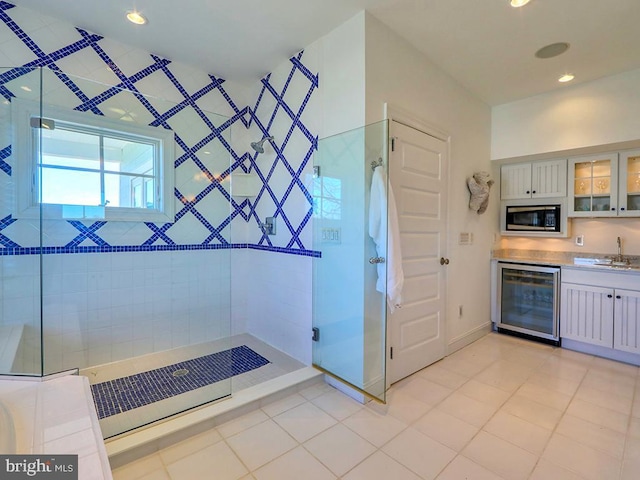 full bath with wine cooler, tile patterned flooring, recessed lighting, vanity, and tiled shower