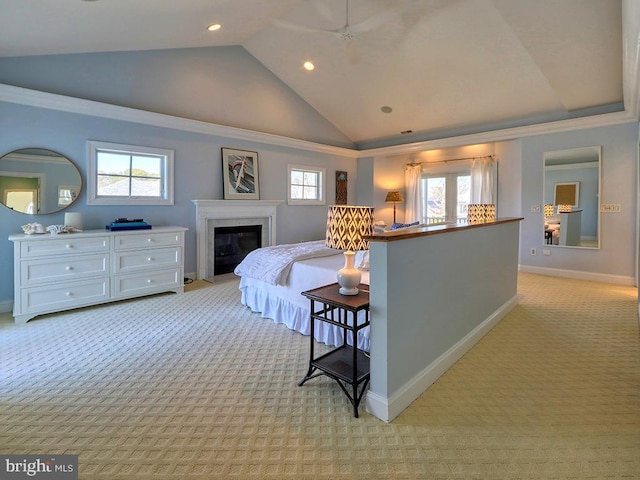 bedroom with vaulted ceiling, multiple windows, baseboards, and light colored carpet