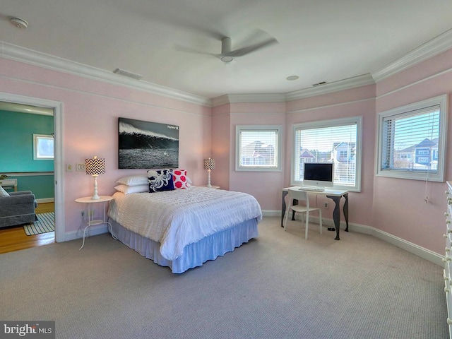 bedroom with baseboards, visible vents, crown molding, and carpet flooring