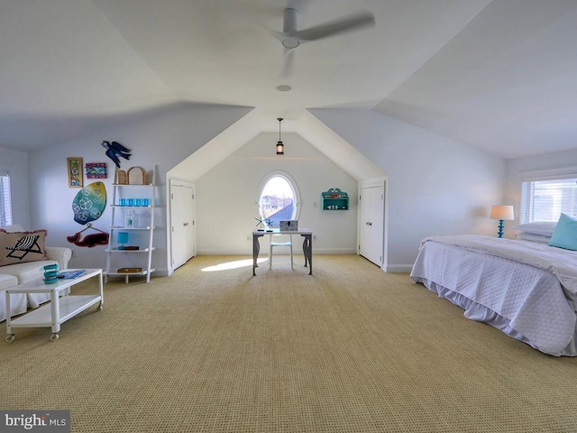 bedroom with ceiling fan, baseboards, vaulted ceiling, and carpet flooring