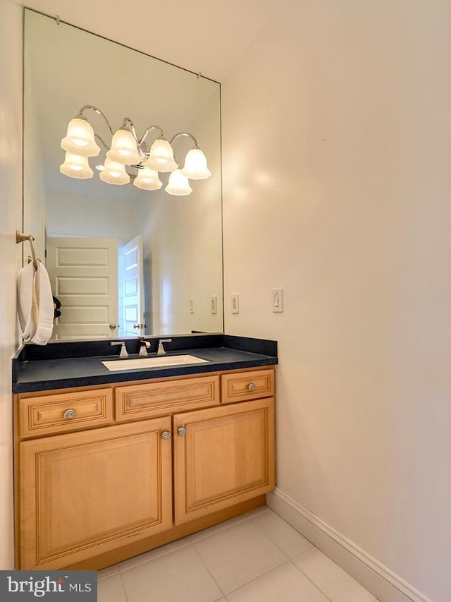 bathroom featuring vanity, baseboards, and tile patterned floors