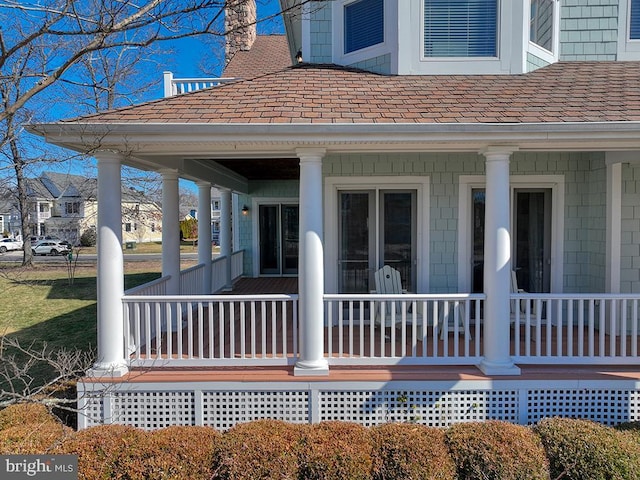 view of side of property featuring covered porch