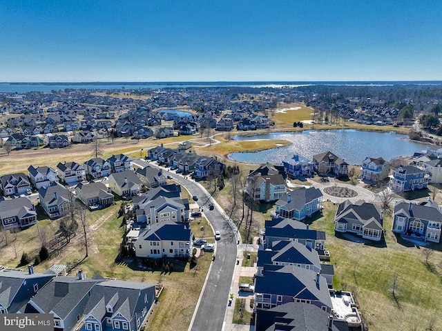 birds eye view of property with a residential view and a water view