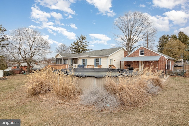 back of property featuring fence and brick siding