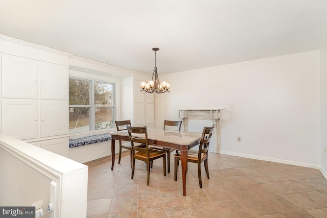 dining room featuring baseboards and an inviting chandelier