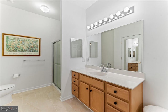 full bath featuring a shower with shower door, vanity, toilet, and tile patterned floors