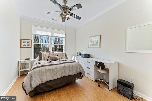 bedroom featuring light wood finished floors, baseboards, visible vents, ceiling fan, and crown molding