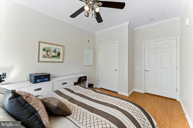 bedroom featuring baseboards, ceiling fan, light wood-type flooring, and crown molding