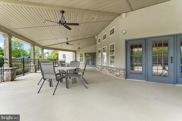 view of patio / terrace featuring visible vents, ceiling fan, fence, outdoor dining area, and french doors