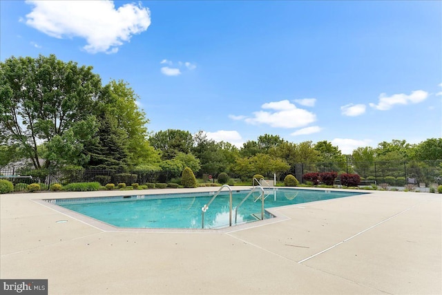 pool with fence and a patio