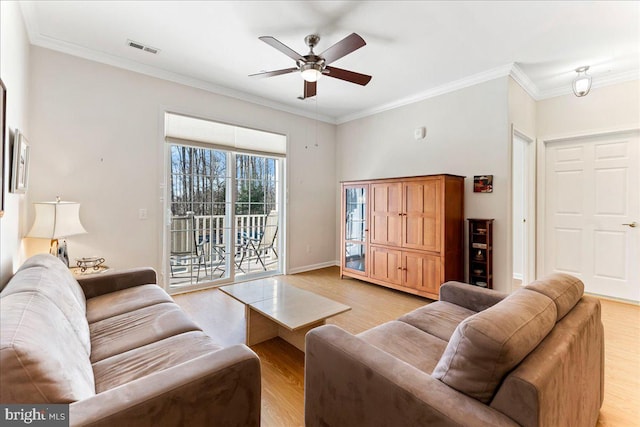 living room with ornamental molding, ceiling fan, light wood-style flooring, and visible vents