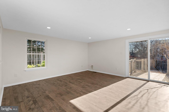 unfurnished room featuring recessed lighting, wood finished floors, and baseboards