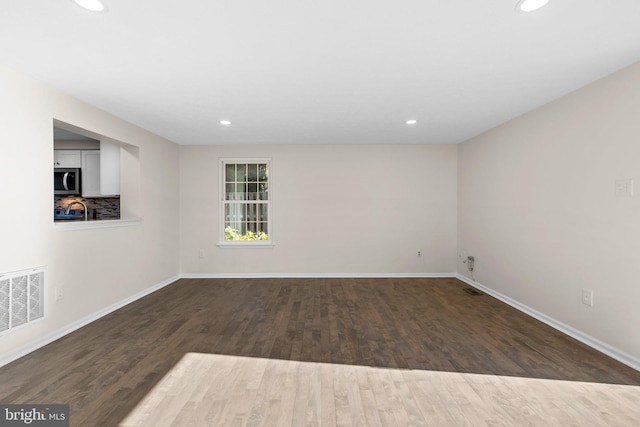 unfurnished room with visible vents, recessed lighting, and wood finished floors