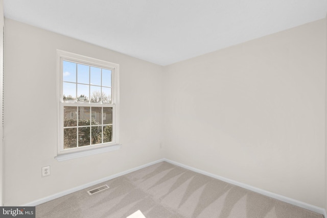 unfurnished room featuring baseboards, visible vents, and carpet floors