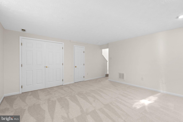 interior space featuring visible vents, carpet flooring, and baseboards