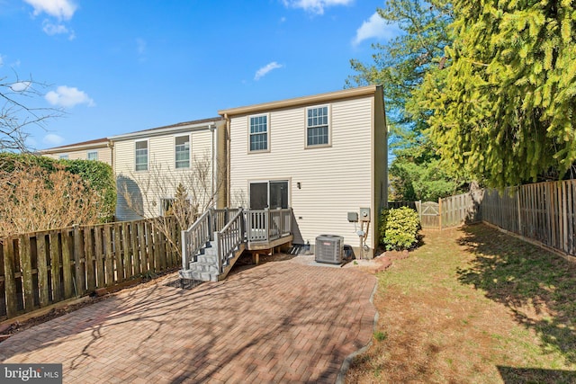 back of house featuring a patio area, central AC unit, and a fenced backyard