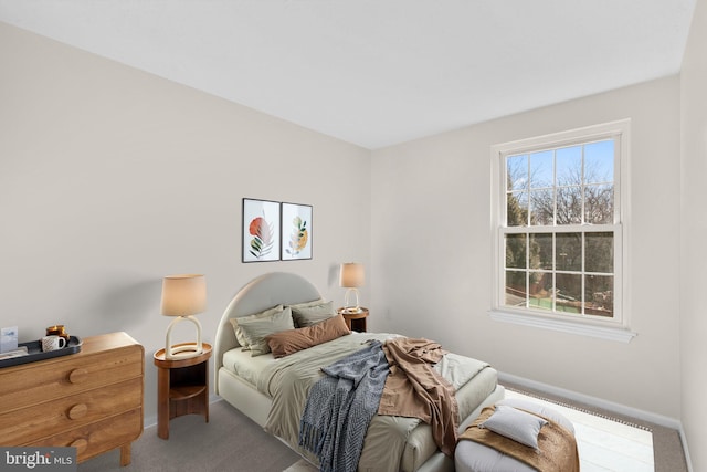 bedroom featuring baseboards and carpet floors