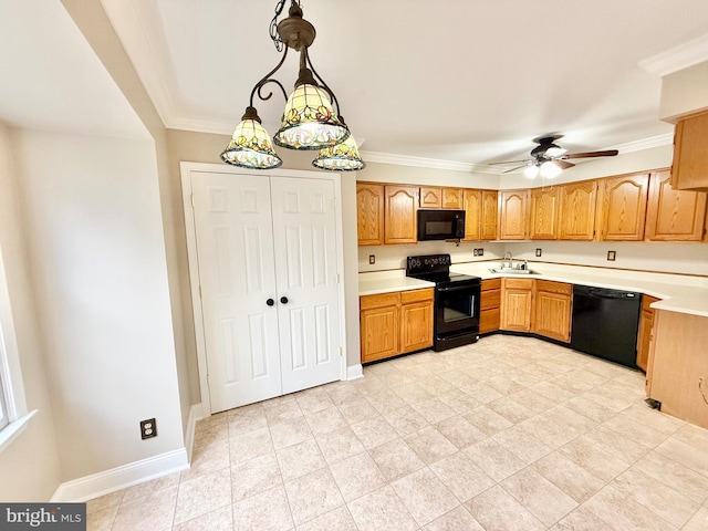 kitchen with baseboards, light countertops, crown molding, black appliances, and a sink