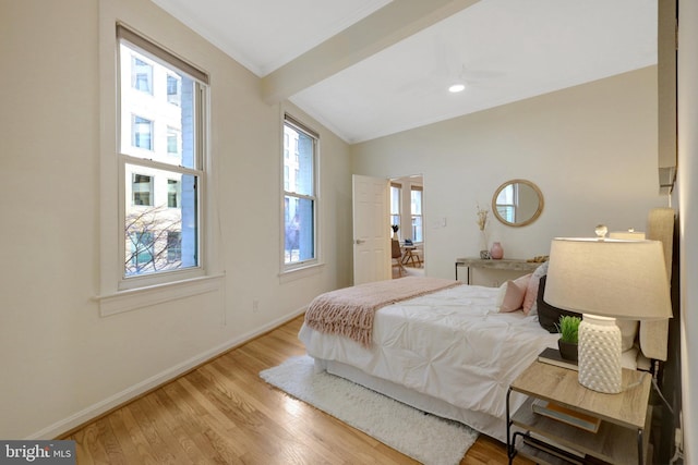 bedroom with ornamental molding, light wood-type flooring, and baseboards